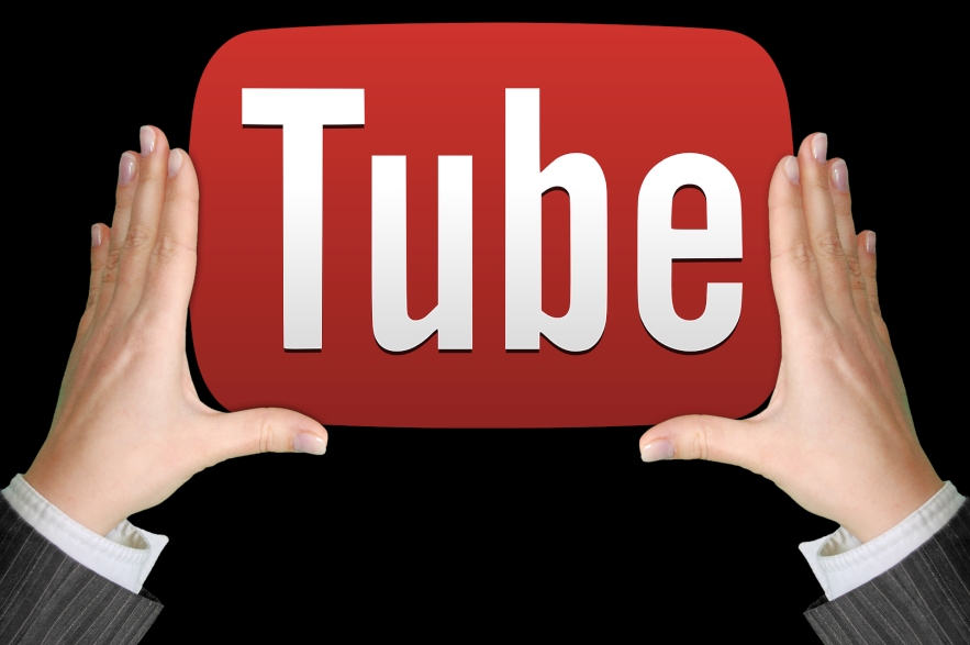 youtube sign, male hands holding it